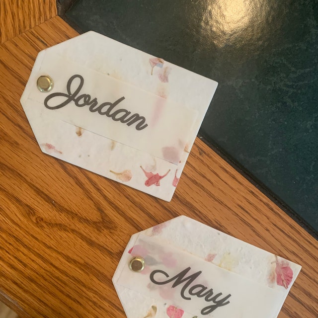 seed paper tags with grommet and guest name